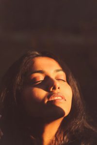 woman with face in the sun